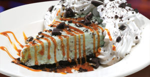 ASPHALT PIE - Mint chocolate chip ice cream on an Oreo crust, smothered with our Caramel Sauce and topped with real whipped cream.